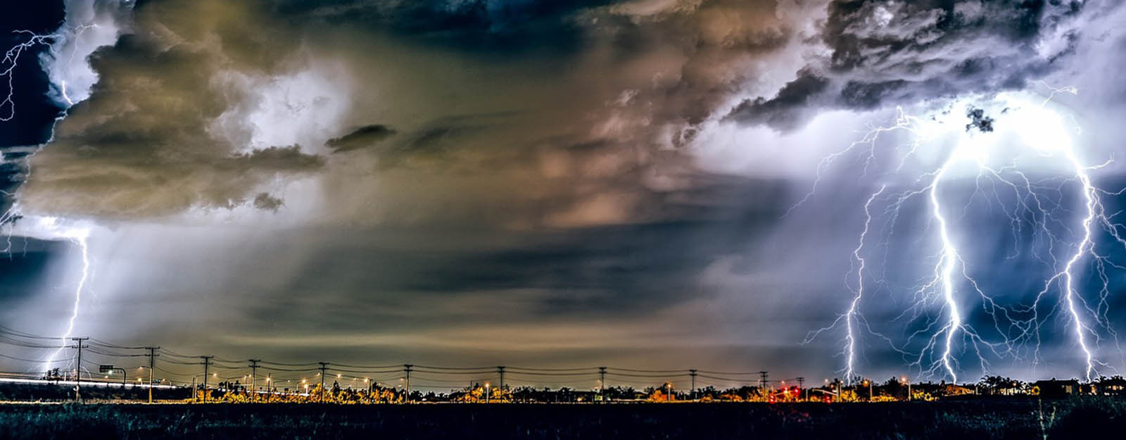 Photograph of a thunderstorm over a small town.